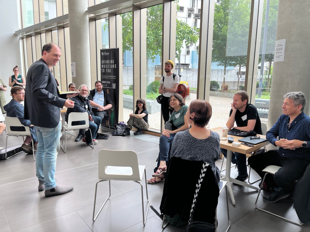 John Hails speaks to a group of conference delegates.